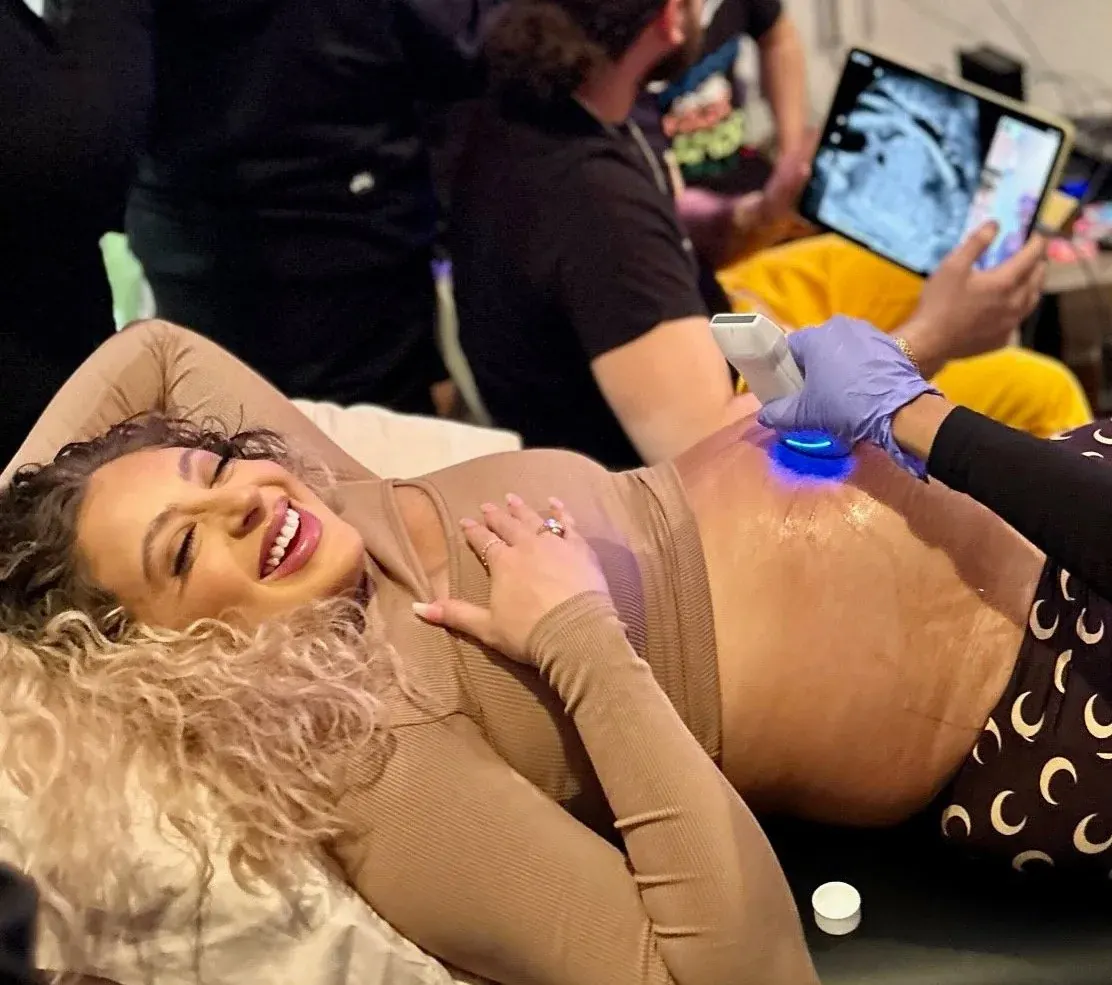 An expectant mother smiles during a reassurance ultrasound
